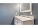 Bathroom vanity with white cabinets and marble countertop at 1040 Hope St, Venice, FL 34285