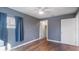Simple bedroom with wood-look floors, neutral walls, and ample closet space at 1040 Hope St, Venice, FL 34285