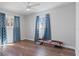 Bright bedroom with wood-look floors and ceiling fan at 1040 Hope St, Venice, FL 34285