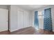 Bedroom with wood floors and double door closet at 1040 Hope St, Venice, FL 34285