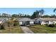 Quaint light teal single-story house with a fenced backyard at 1040 Hope St, Venice, FL 34285