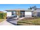 Newly renovated light teal single story home with a screened porch at 1040 Hope St, Venice, FL 34285