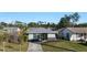 Single-story home with gray roof, stone accents, and a paved driveway at 1040 Hope St, Venice, FL 34285