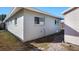 Side view of the house showcasing its light green exterior at 1040 Hope St, Venice, FL 34285