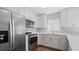 Modern kitchen with white cabinets and stainless steel appliances at 1040 Hope St, Venice, FL 34285
