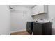 Laundry room with washer, dryer, and overhead shelving at 1040 Hope St, Venice, FL 34285