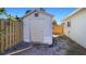 White storage shed with a wooden door at 1040 Hope St, Venice, FL 34285