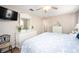 Bedroom with white dresser, large bed, and ensuite bathroom at 108 Hourglass Dr, Venice, FL 34293