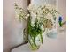 White dresser with mirror and flowers sits in a bedroom at 108 Hourglass Dr, Venice, FL 34293