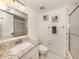 Clean bathroom with granite countertop and a walk-in shower at 1100 Capri Isles Blvd # 212, Venice, FL 34292