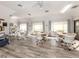 Spacious community room with multiple tables and chairs at 1100 Capri Isles Blvd # 212, Venice, FL 34292