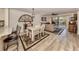 Elegant dining area with a white table and chairs, hardwood floors, and access to the living room at 1100 Capri Isles Blvd # 212, Venice, FL 34292