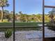 Screened patio overlooking a tranquil pond and lush greenery at 1100 Capri Isles Blvd # 212, Venice, FL 34292
