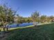 Serene pond view, reflecting the surrounding trees and sky at 1100 Capri Isles Blvd # 212, Venice, FL 34292