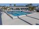 Community pool with plenty of lounge chairs at 1100 Capri Isles Blvd # 212, Venice, FL 34292