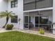 Spacious screened patio with seating and water view at 1100 Capri Isles Blvd # 212, Venice, FL 34292