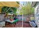 Backyard with covered patio, wooden fence, and various plants at 113 Colonia W Ln, Nokomis, FL 34275