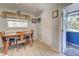 Small dining area with wooden table and chairs, near an exterior door at 113 Colonia W Ln, Nokomis, FL 34275