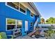 Blue house with brick pathway, and nicely landscaped yard at 113 Colonia W Ln, Nokomis, FL 34275