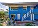 Blue house with brick pathway, and nicely landscaped yard at 113 Colonia W Ln, Nokomis, FL 34275