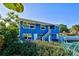 Charming blue house with boat and landscaped yard at 113 Colonia W Ln, Nokomis, FL 34275