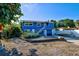 Charming blue house with boat and landscaped yard at 113 Colonia W Ln, Nokomis, FL 34275