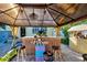 Tropical-themed gazebo with tiki bar and seating at 113 Colonia W Ln, Nokomis, FL 34275