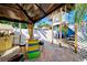 Covered patio area with colorful bar and seating at 113 Colonia W Ln, Nokomis, FL 34275