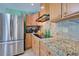 Kitchen with granite countertops and stainless steel appliances at 113 Colonia W Ln, Nokomis, FL 34275