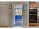 Laundry area with access to a covered patio at 113 Colonia W Ln, Nokomis, FL 34275