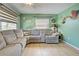 Living room with large sectional sofa and ceiling fan at 113 Colonia W Ln, Nokomis, FL 34275