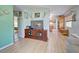 Bright living room featuring hardwood floors and built-in shelving at 113 Colonia W Ln, Nokomis, FL 34275