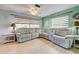 Living room with large sectional sofa and two windows at 113 Colonia W Ln, Nokomis, FL 34275