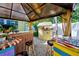 Relaxing patio with tiki bar and seating area at 113 Colonia W Ln, Nokomis, FL 34275