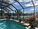 Enclosed pool and lanai overlooking a lake, providing a relaxing outdoor space at 114 Medici Ter, North Venice, FL 34275