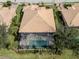Aerial view of home with pool and spa, screened enclosure, and lush landscaping at 114 Medici Ter, North Venice, FL 34275