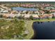 Aerial view showcasing community near a tranquil lake setting at 114 Medici Ter, North Venice, FL 34275
