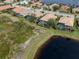 Aerial view showing home's location on a quiet street near a lake at 114 Medici Ter, North Venice, FL 34275