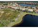 Aerial view of community with lake, conservation, and homes at 114 Medici Ter, North Venice, FL 34275