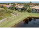 Aerial view of homes situated near a serene lake and conservation at 114 Medici Ter, North Venice, FL 34275
