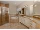 Large bathroom with granite double vanity and soaking tub at 114 Medici Ter, North Venice, FL 34275