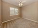 Well-lit bedroom featuring ceiling fan and carpet at 114 Medici Ter, North Venice, FL 34275
