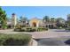 Grand entrance to community center with clock tower and lush landscaping at 114 Medici Ter, North Venice, FL 34275