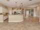 Eat-in kitchen featuring granite island and stainless steel appliances at 114 Medici Ter, North Venice, FL 34275