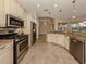 Kitchen with granite countertops, stainless steel appliances, and custom cabinetry at 114 Medici Ter, North Venice, FL 34275