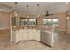 Island kitchen with granite countertops and stainless steel appliances at 114 Medici Ter, North Venice, FL 34275