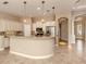 Open kitchen boasting granite countertops and custom cabinetry at 114 Medici Ter, North Venice, FL 34275