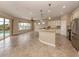 Open kitchen with island, granite counters, and stainless steel appliances at 114 Medici Ter, North Venice, FL 34275