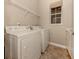 Laundry room with washer, dryer, and overhead shelving at 114 Medici Ter, North Venice, FL 34275