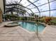 Screened pool and spa with lush landscaping and outdoor seating at 114 Medici Ter, North Venice, FL 34275